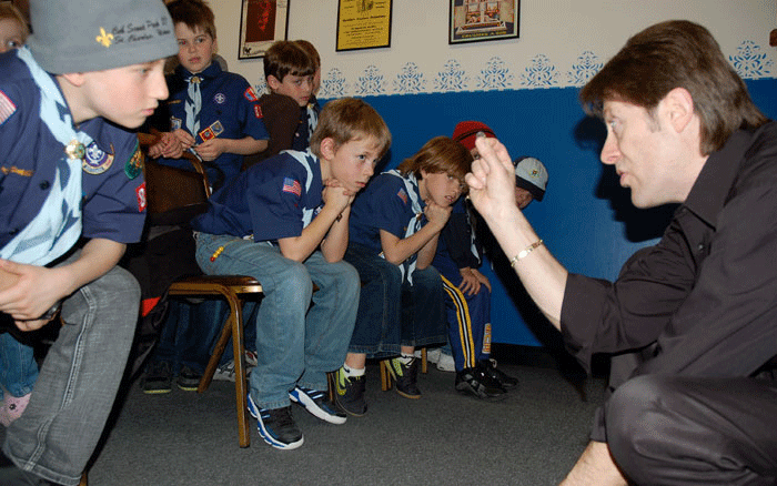 Boy Scouts learn a trick in the magic workshop